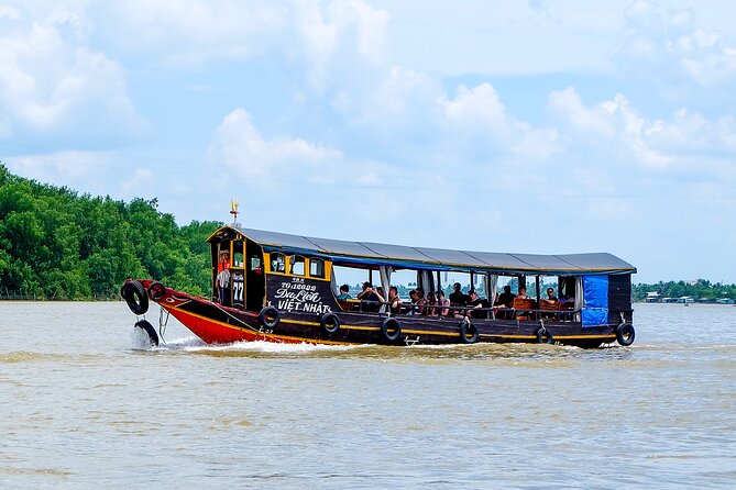 Small-Group Mekong Delta Day Trip: Boat Ride, Cottages & Pagoda - Motorboat canals and the Rạch Miễu Bridge viewpoint